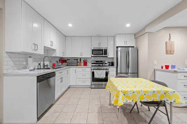 a kitchen with sink cabinets and stainless steel appliances