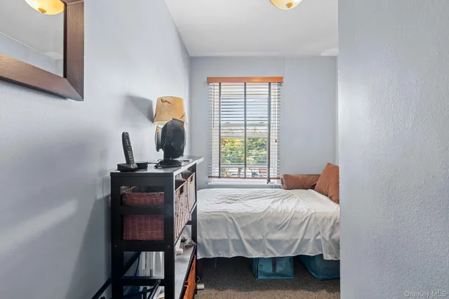 a bedroom with a bed and a table in it