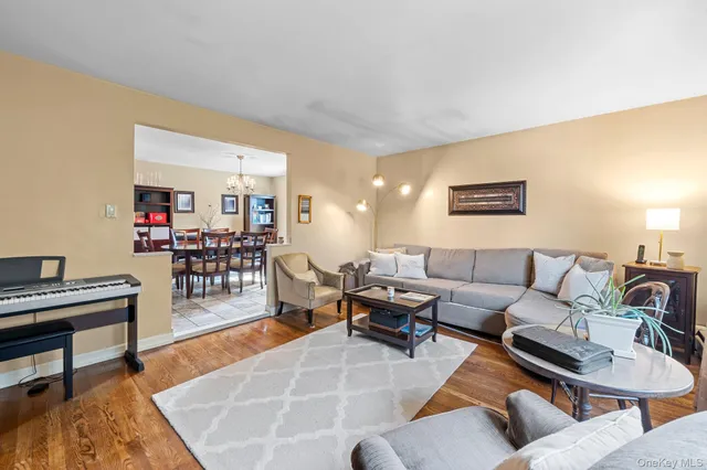 a living room with furniture a rug and a table