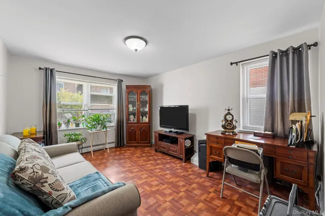 a bedroom with furniture and a flat screen tv