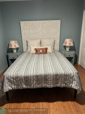 a bedroom with a bed and mirror