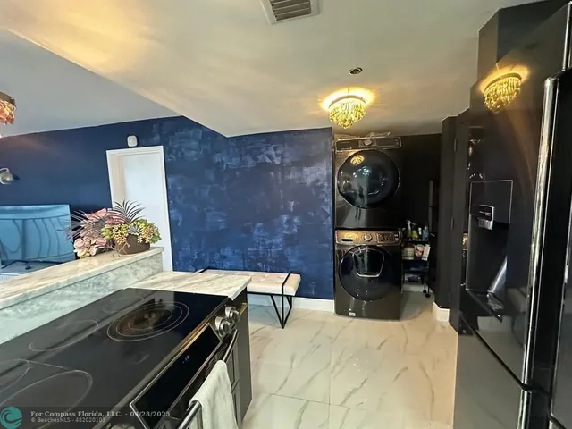 a kitchen with a sink appliances and cabinets