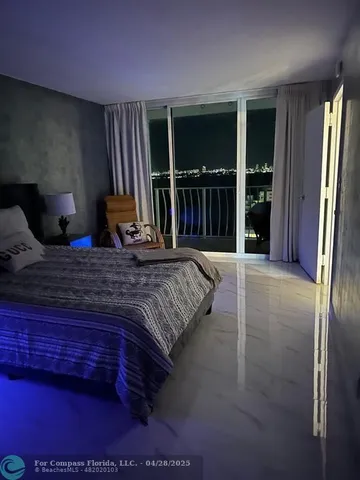 a bedroom with a bed and large window