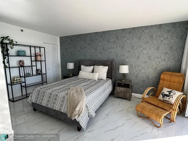 a bedroom with a bed and a couch