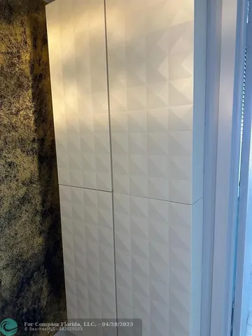 a bathroom with a glass shower door