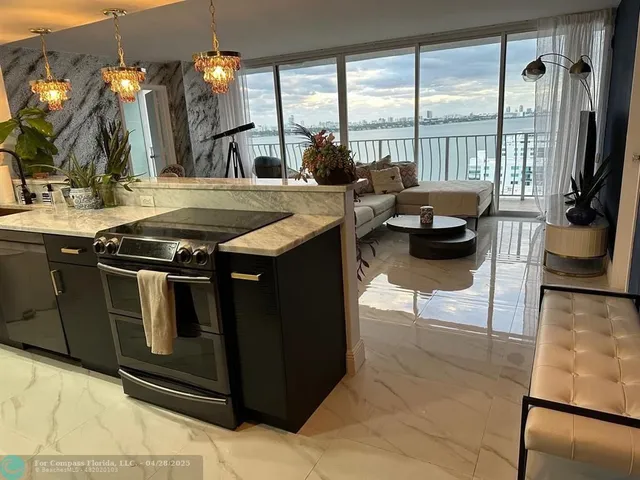 a kitchen with stainless steel appliances granite countertop a sink and a stove
