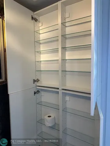 a view of walk in closet with empty racks