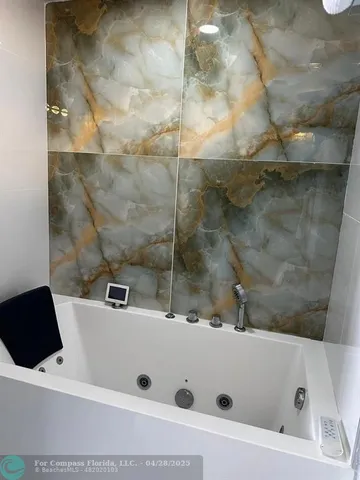 a bathroom with a bathtub and a shower