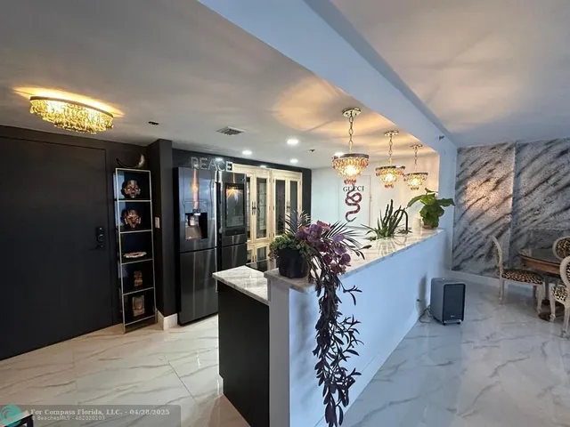 a lobby with furniture and potted plants