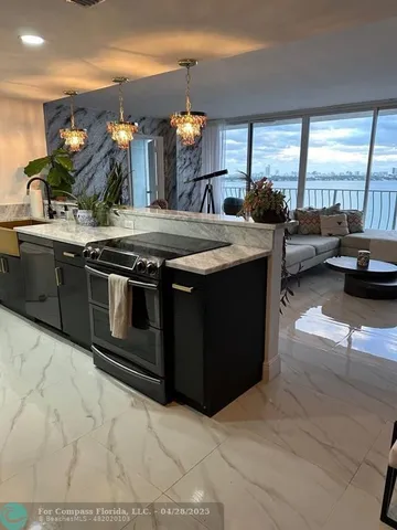a kitchen with stainless steel appliances granite countertop a sink and a stove