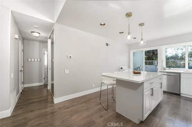 a view of kitchen with a sink and wooden floor