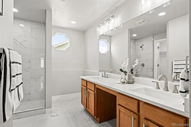 a bathroom with a double vanity sink mirror and double