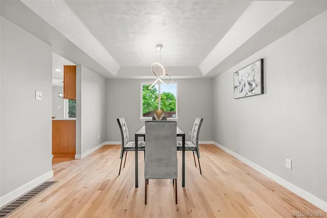 a view of a dining room with furniture window and wooden floor