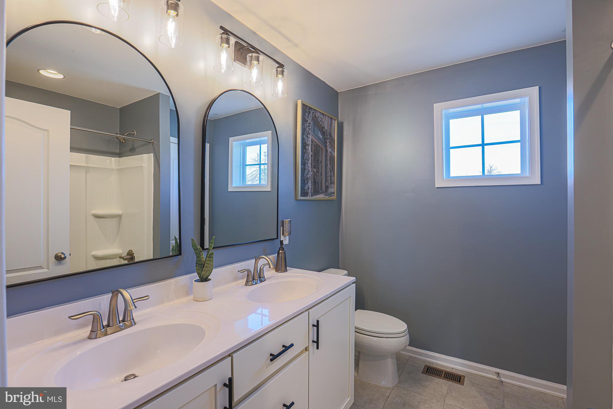 809 Jefferson Pike Brunswick, MD 21716 - Photo 32 of 64 a bathroom with a toilet sink and mirror