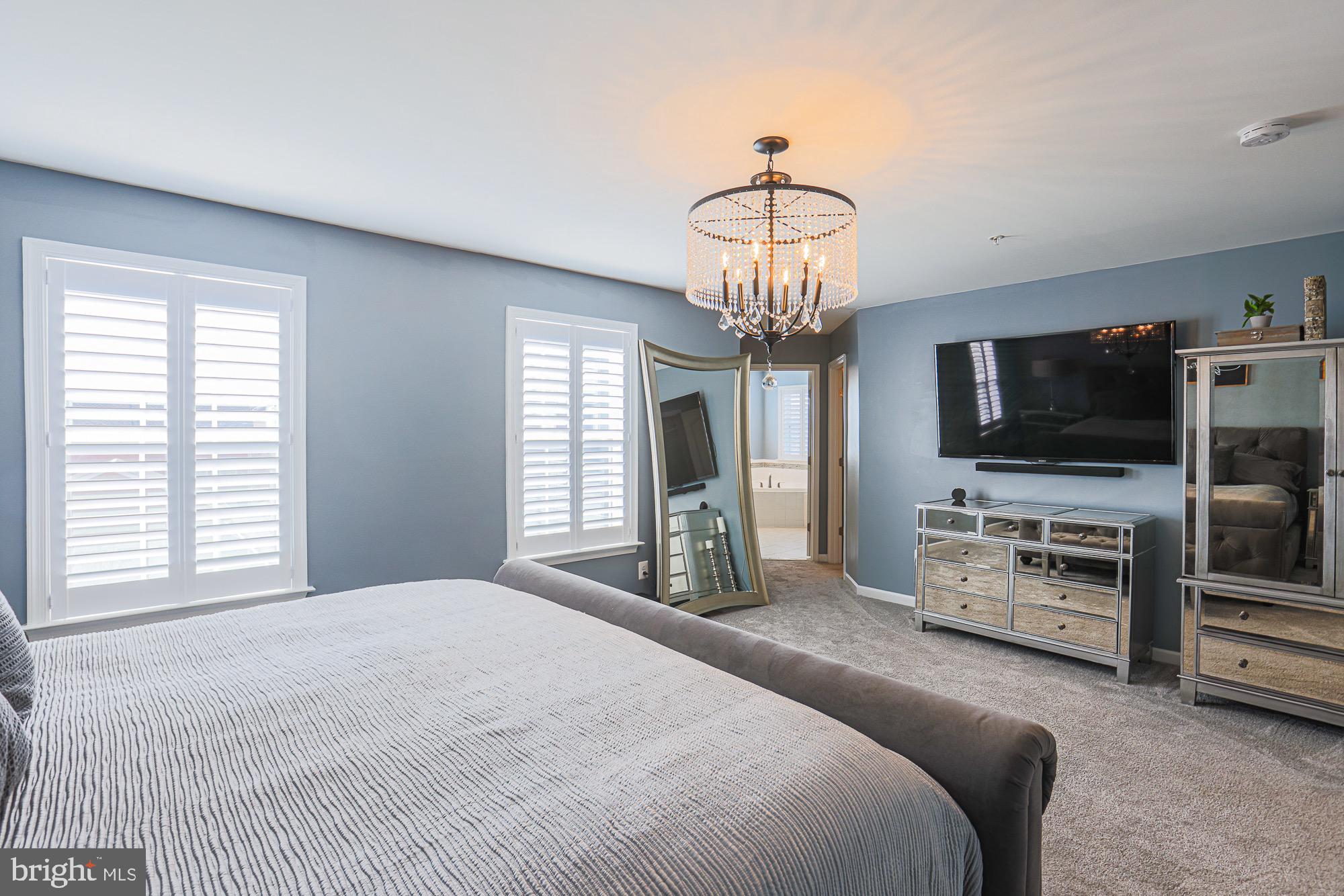 809 Jefferson Pike Brunswick, MD 21716 - Photo 37 of 64 a spacious bedroom with a bed and a flat screen tv