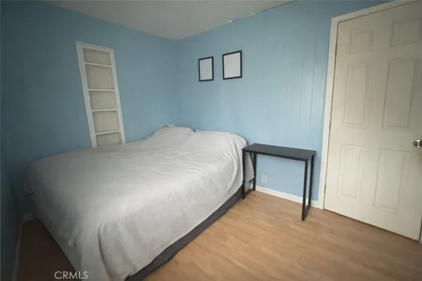 a bed sitting in a bedroom next to a window