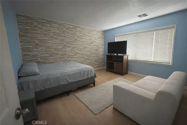 a bedroom with a bed and a couch