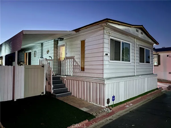 a front view of a house with wooden fence