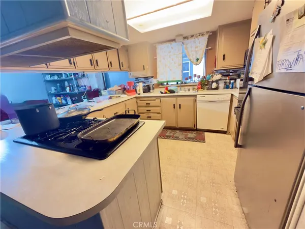 a kitchen with stainless steel appliances granite countertop a sink a stove and a refrigerator