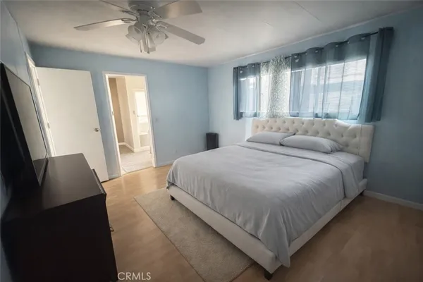 a bedroom with a large bed and a window