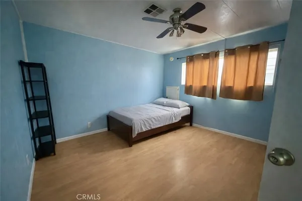 a spacious bedroom with a bed and a window