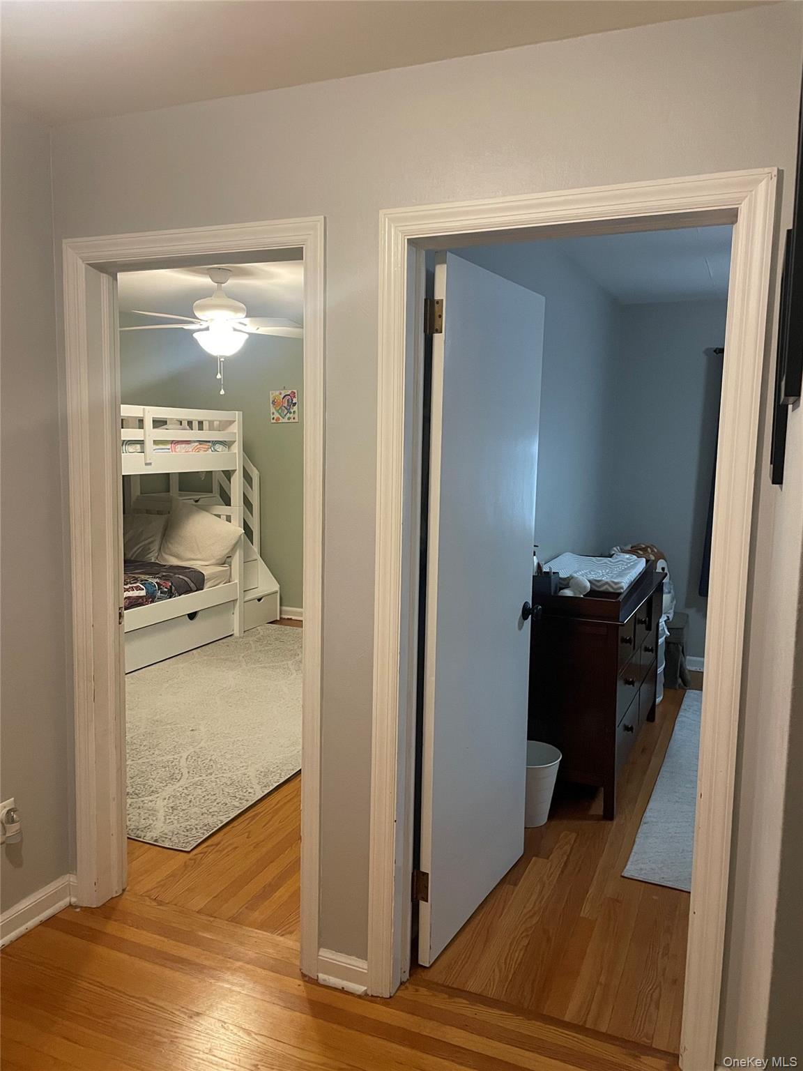 291 North Little Tor Road New City, NY 10956 - Photo 12 of 25 a view of a hallway with wooden floor and a living room