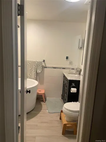 a white toilet sitting next to a bathroom sink