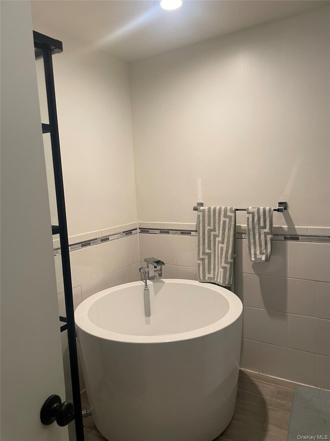 291 North Little Tor Road New City, NY 10956 - Photo 16 of 25 a white bath tub sitting in a bathroom