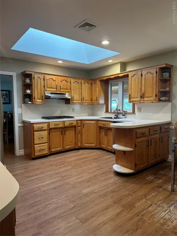 a kitchen with stainless steel appliances granite countertop a sink and cabinets