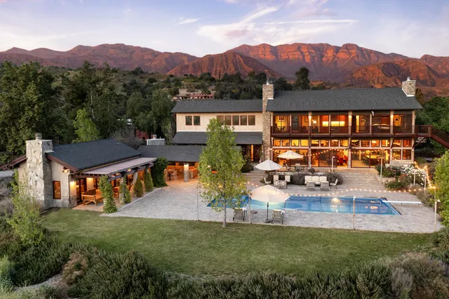 a view of a house with pool and a garden