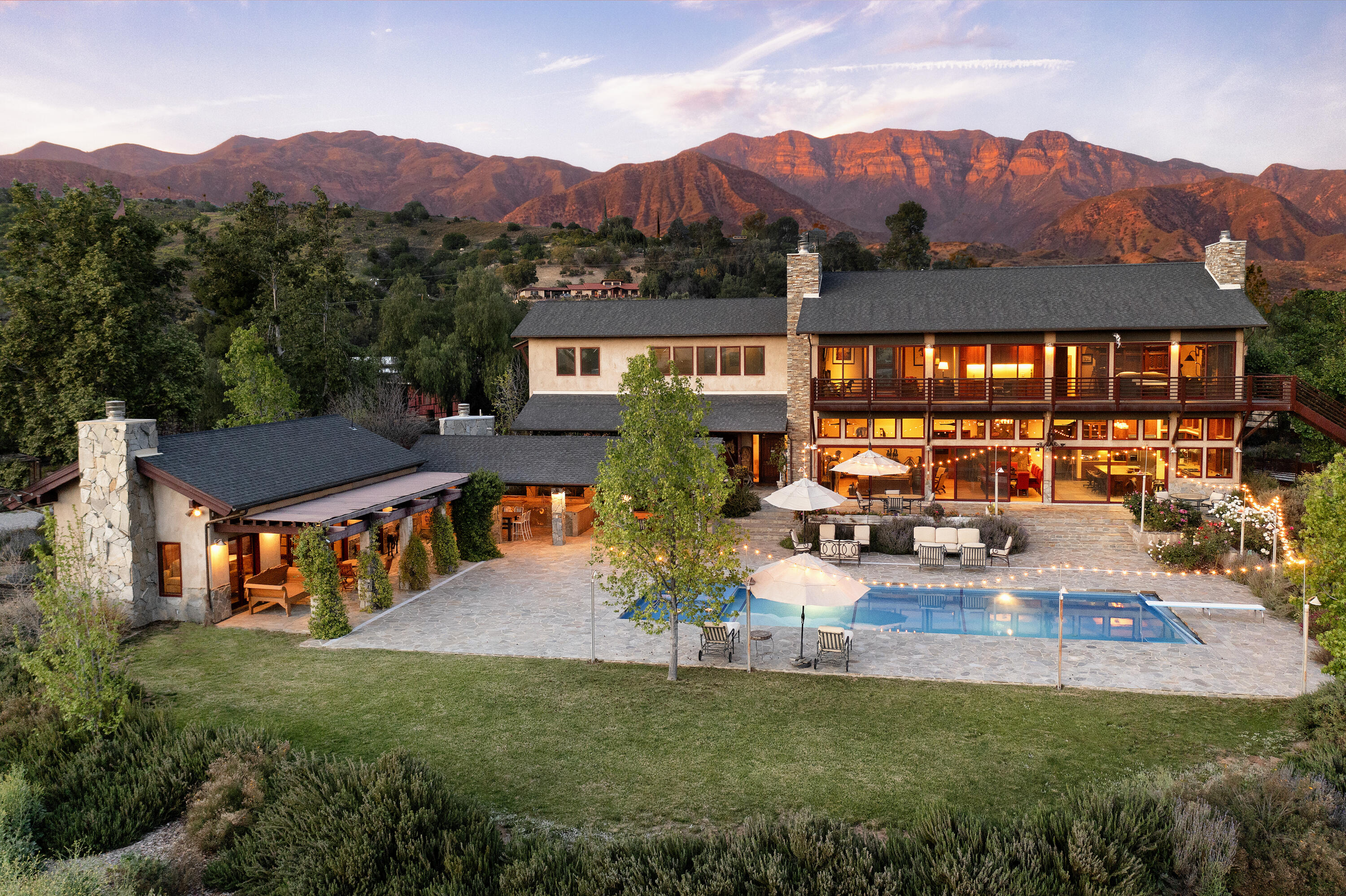 a view of a house with pool and a garden