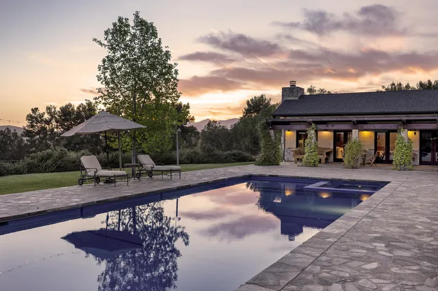 a front view of a building with sitting area