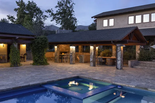 a view of a swimming pool with a mountain in the background