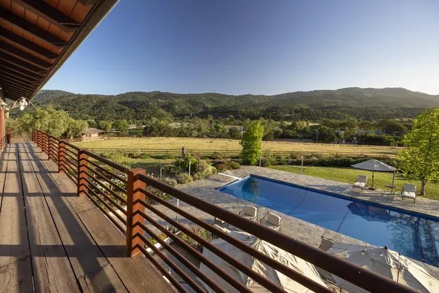 a bedroom with a large bed wooden floor and window