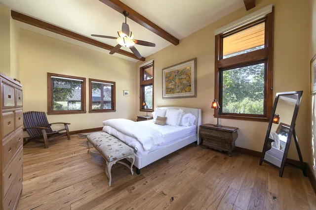 a bedroom with a bed and wooden floor