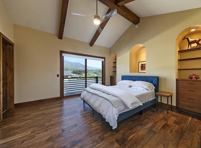 a view of a large building with a mountain and trees