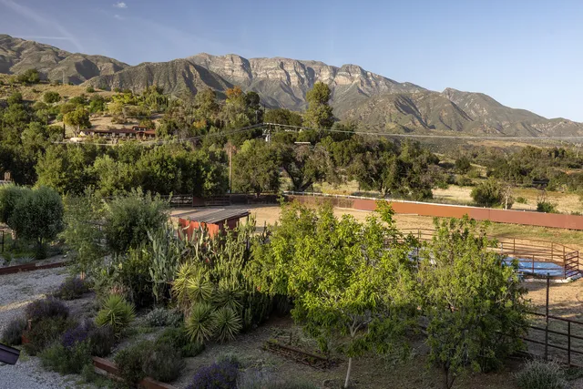 a view of an outdoor dining space with furniture and garden view