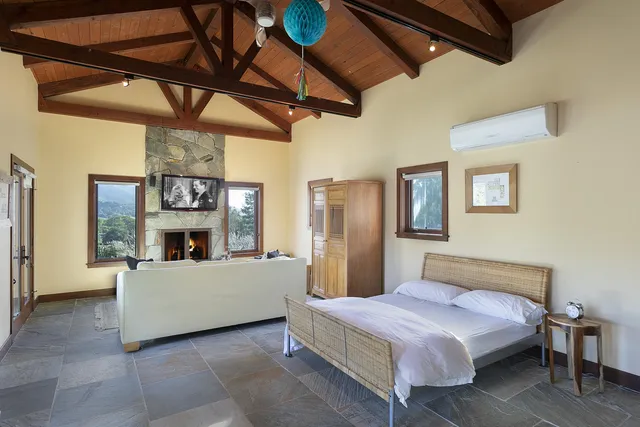 a kitchen with stainless steel appliances granite countertop a refrigerator a stove and a dining table with wooden floors