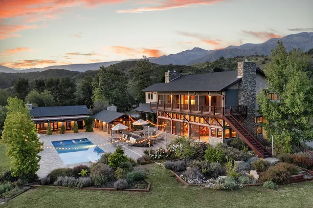 a living room with lots of furniture and a large window