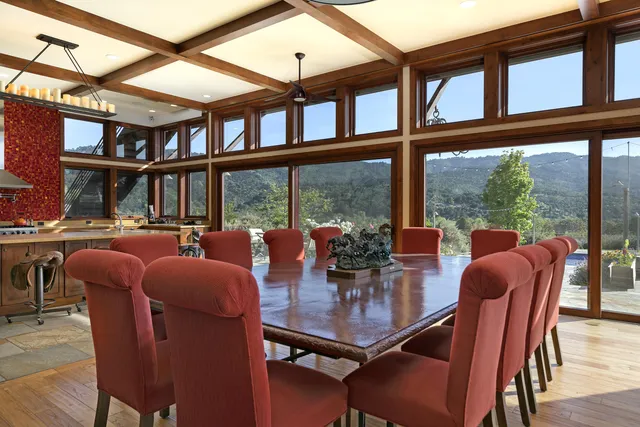 a dinning area with pool table and windows