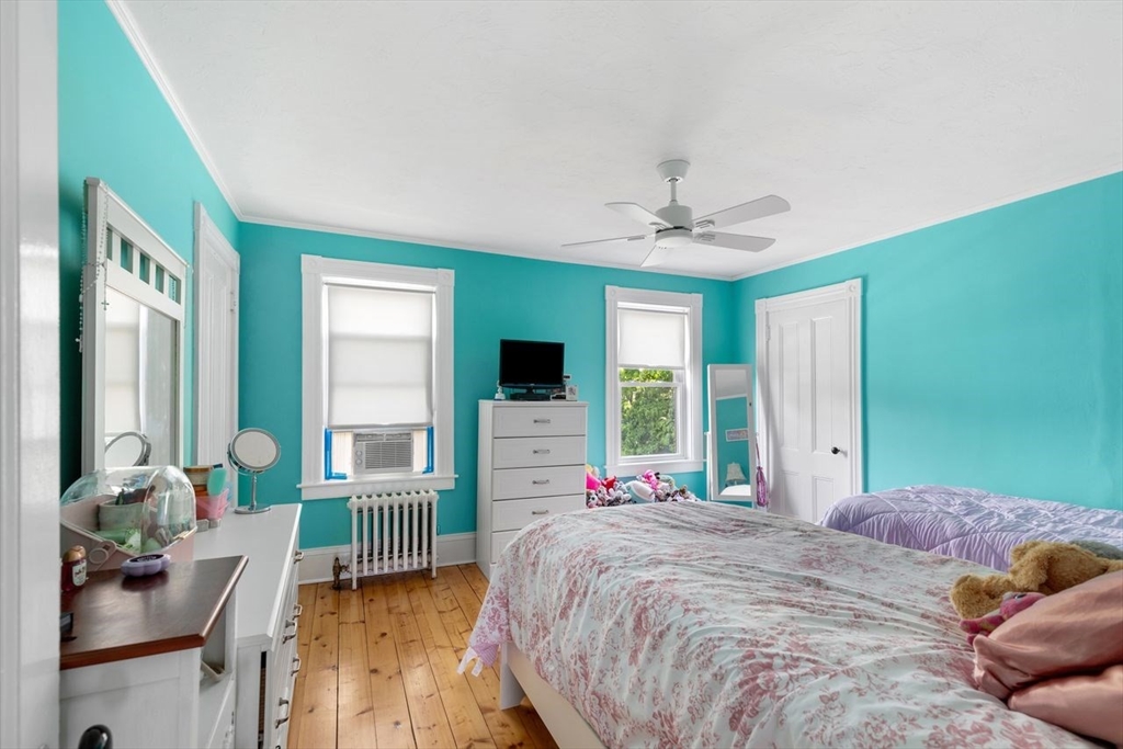 1012 Washington Street Whitman, MA 02382 - Photo 26 of 37 a bedroom with a bed and a chandelier