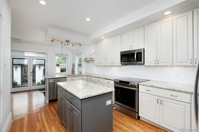 a kitchen with a sink stove and microwave