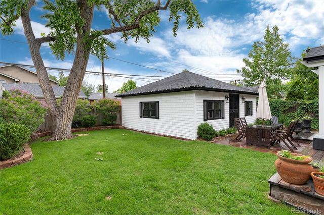 a view of a chair and table in the garden