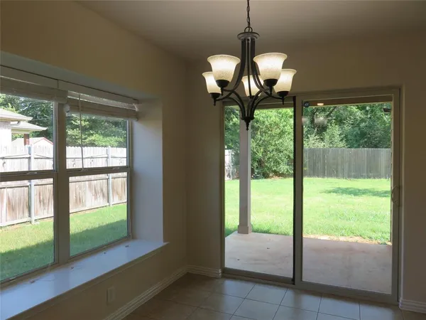 a view of a room with window ceiling fan