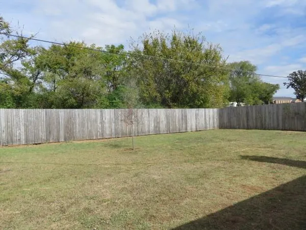 a view of outdoor space with wooden fence