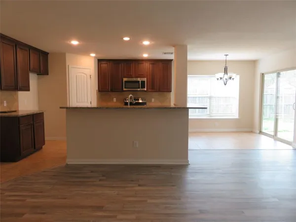 a kitchen with stainless steel appliances a refrigerator sink and microwave