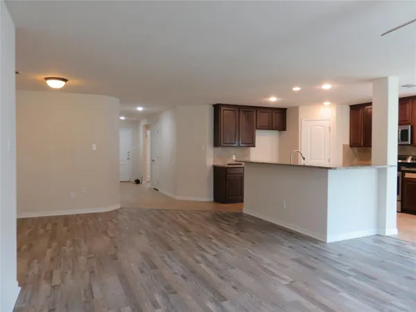 a view of a kitchen with a sink and a refrigerator