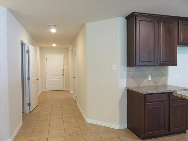 a view of hallway with kitchen