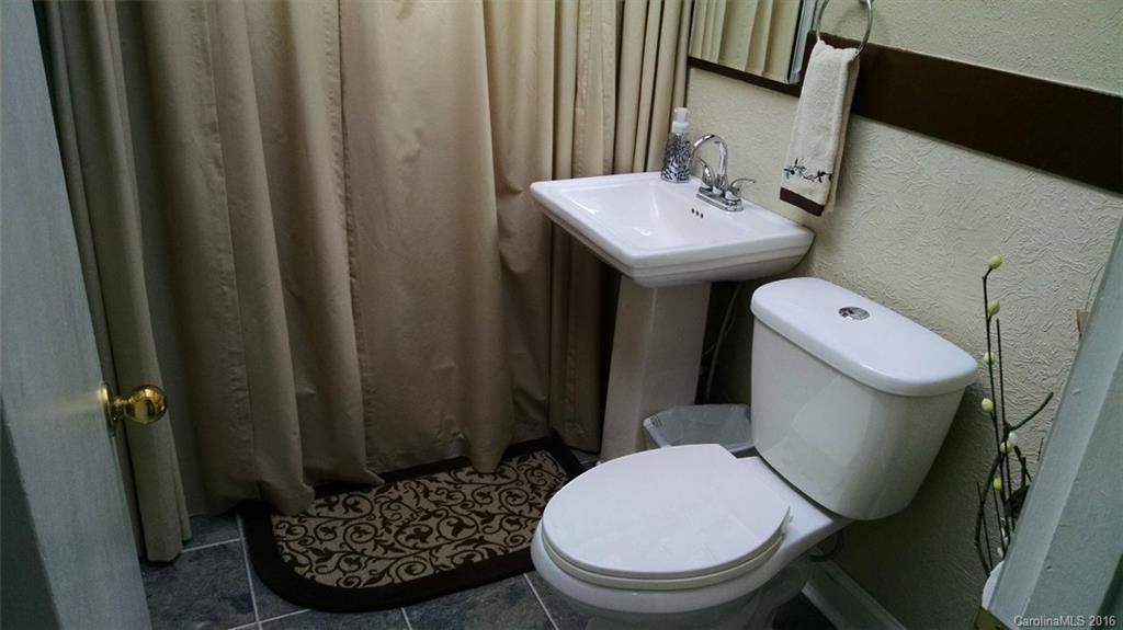 1978 Ridge Road Hendersonville, NC 28792 - Photo 11 of 18 a white toilet sitting next to a bathroom sink