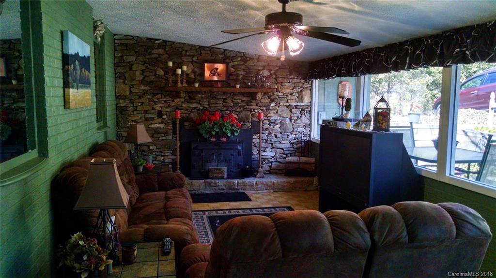 1978 Ridge Road Hendersonville, NC 28792 - Photo 4 of 18 a living room with patio furniture and a fireplace